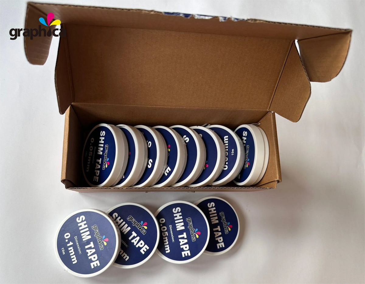 Assorted rolls of shim tape in a cardboard box