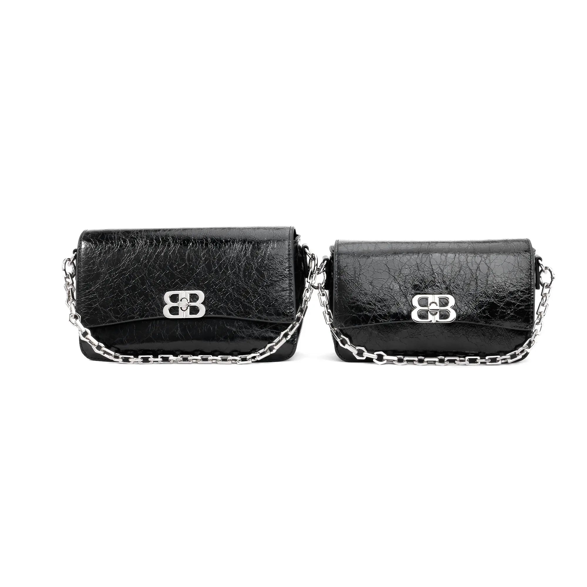 Black designer leather shoulder bags with silver chain straps and metallic clasp closures in two sizes.