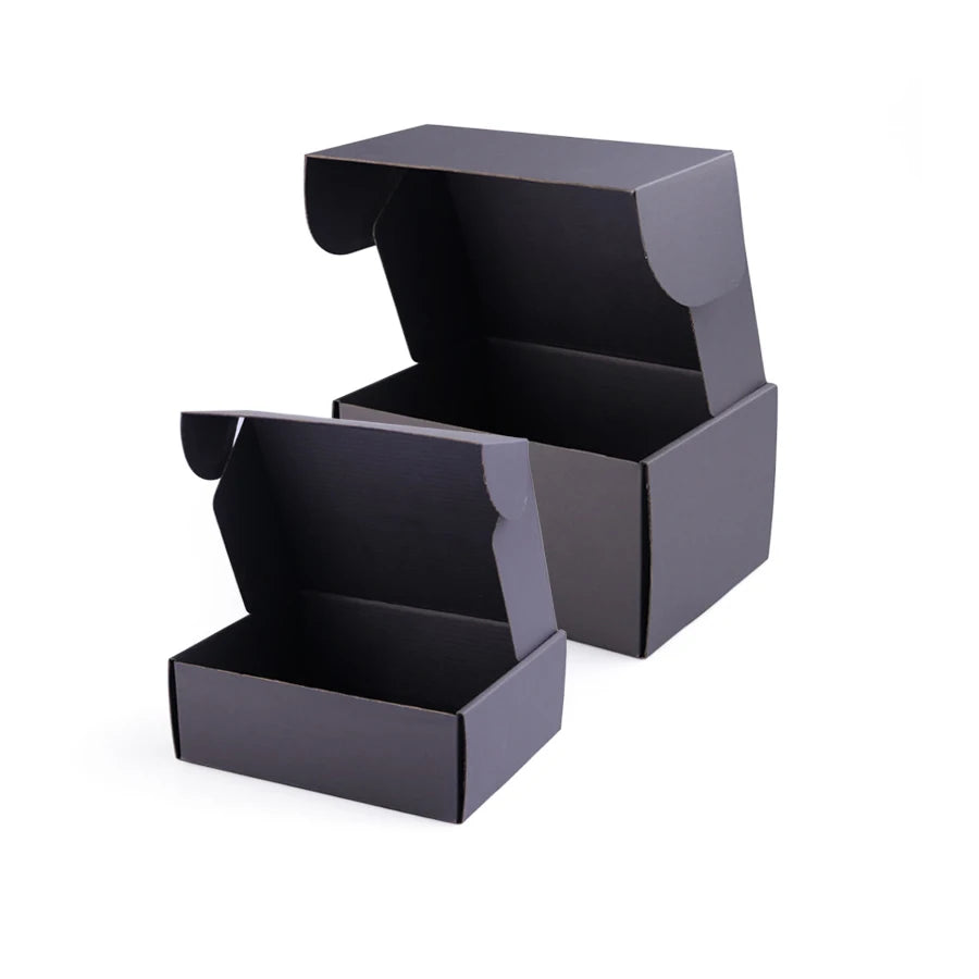 Black shipping mailer boxes with open hinged lids, stacked for apparel shipping.