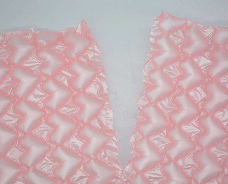Pink bubble wrap sheets with repeating textured air-cushion pattern