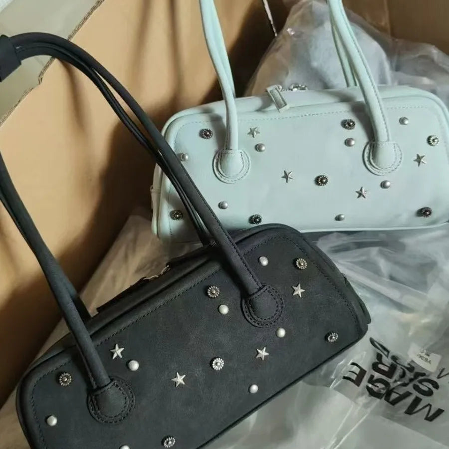 Black and mint green Korean locomotive-style trunk tote bags with star studs, two handles, and zipper closures.