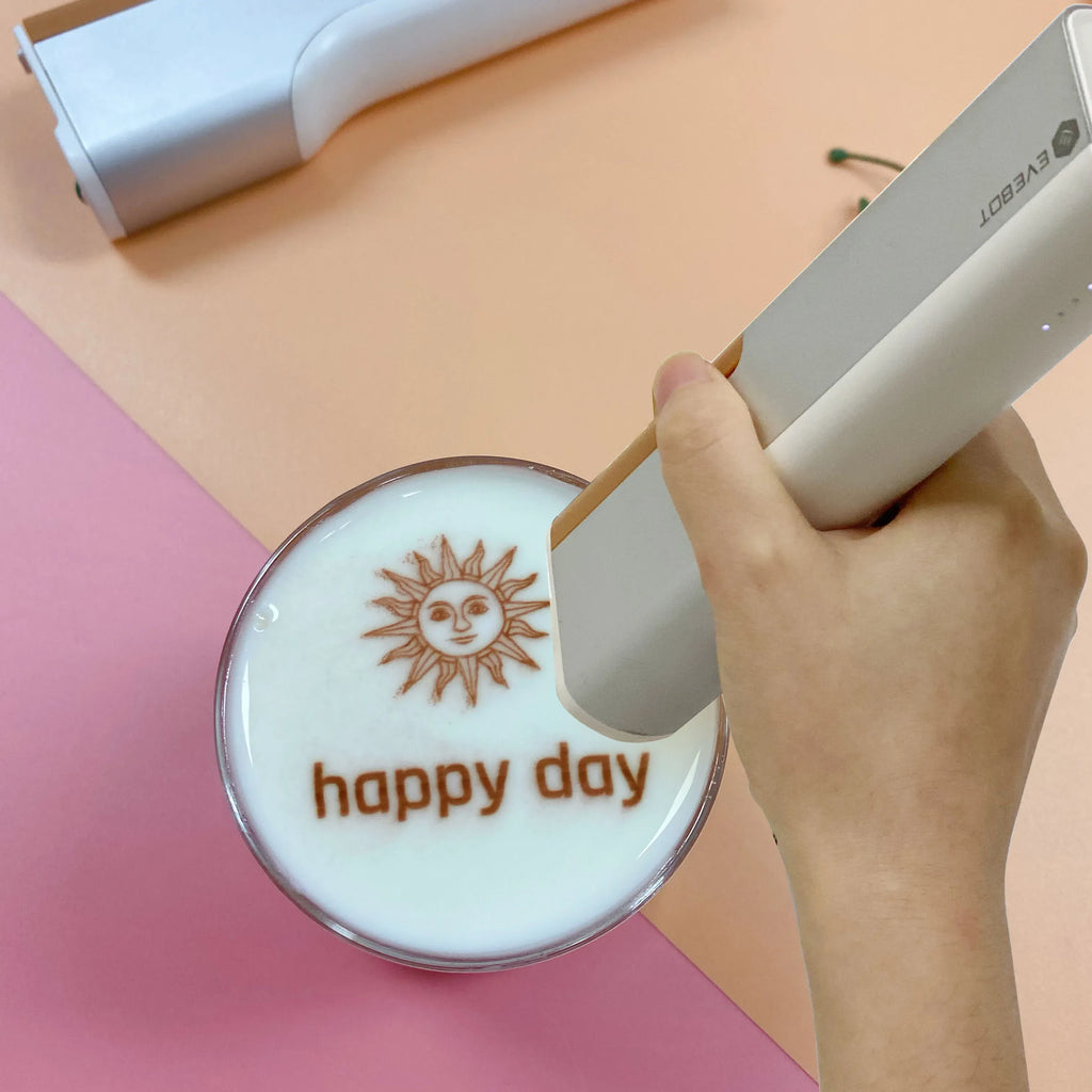 Handheld edible inkjet printer printing on a round cookie with “happy day” design.
