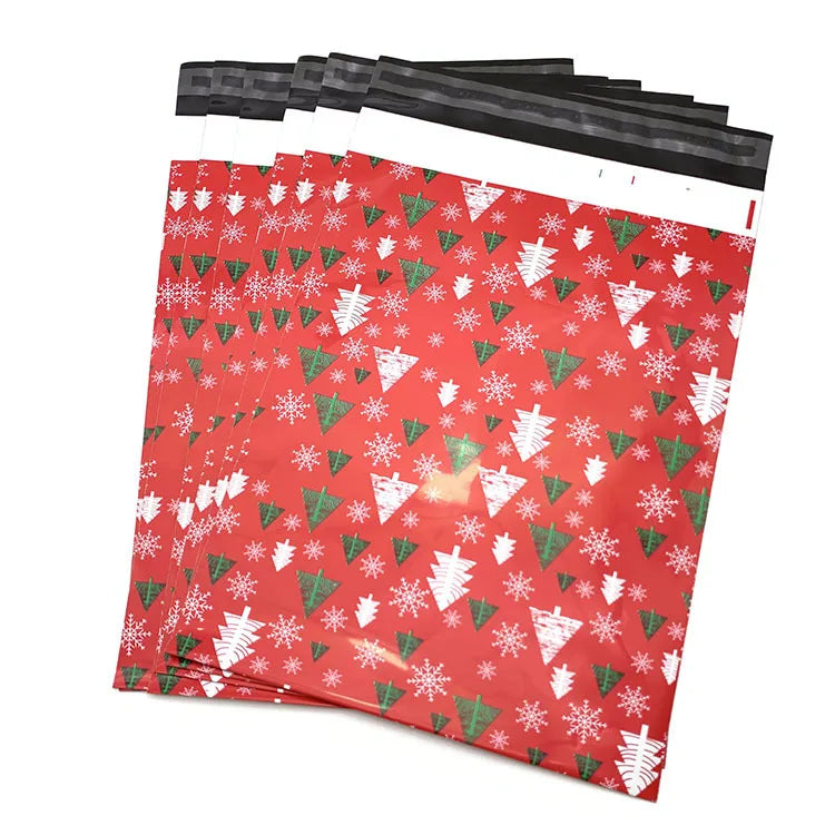 Red poly mailer bags with white snowflake pattern and green accents; top handle band