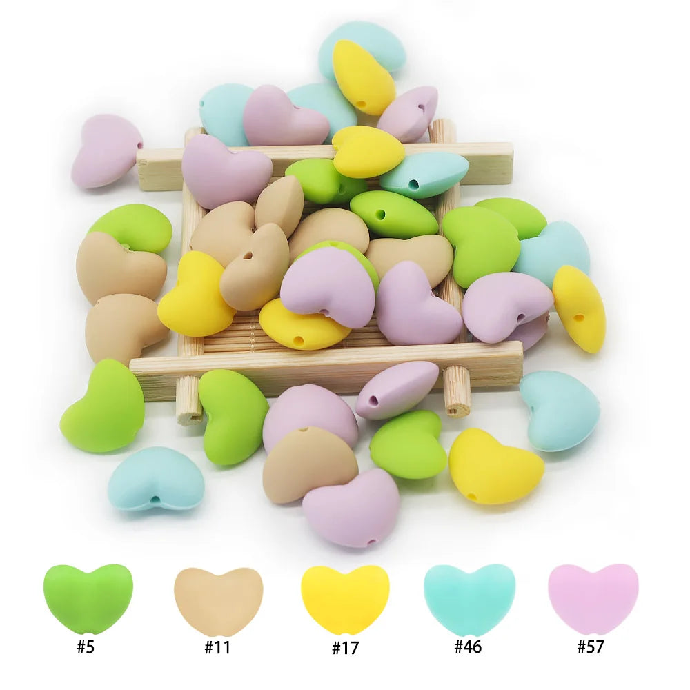 Multicolored heart silicone teething toy beads for DIY baby teething jewelry in pastel and bright colors.