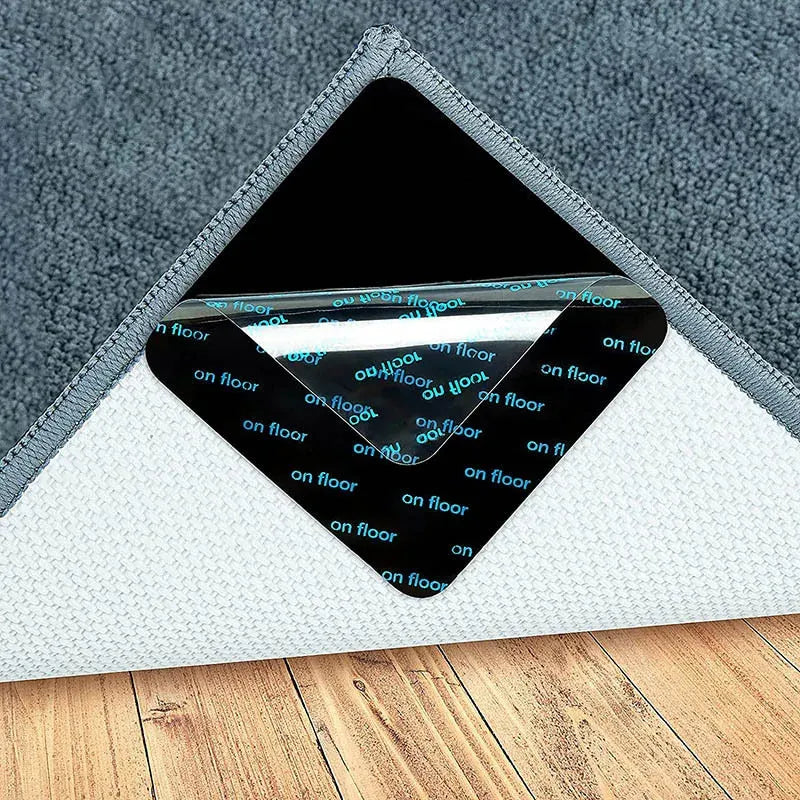 Square double-sided carpet grip pad, black adhesive side, placed under rug corner