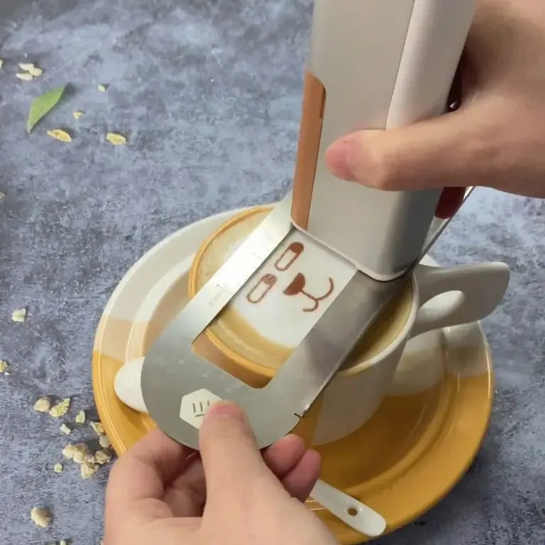 Handheld edible inkjet printer printing on a small cake slice with “love” outline.