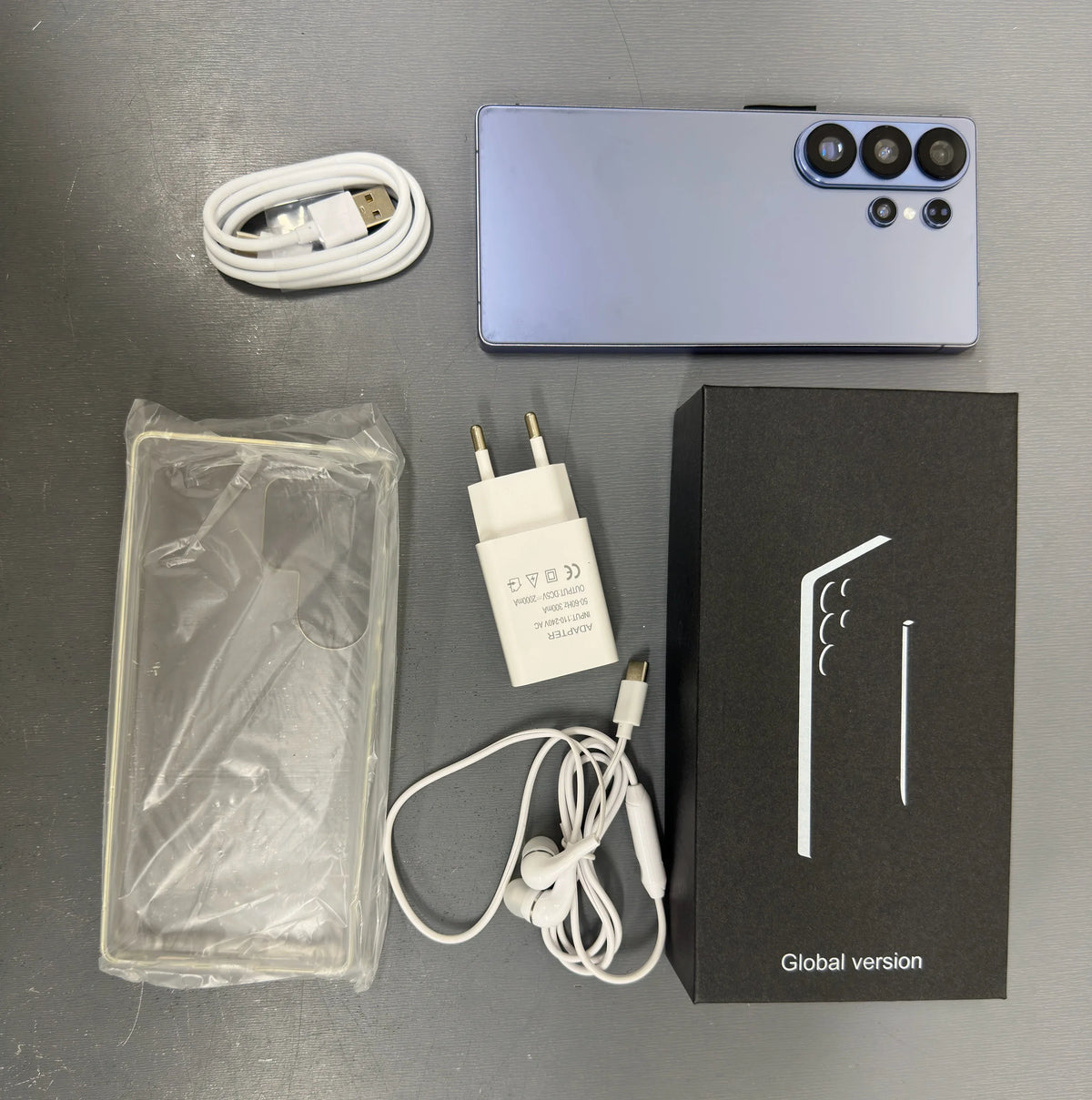 Light blue smartphone back with quad camera module; includes charging cable and box