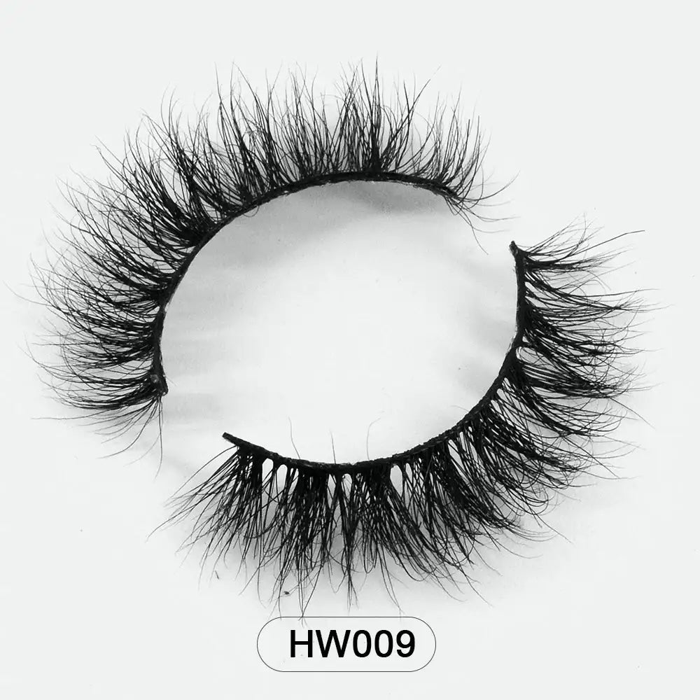 Fluffy black 3D mink false eyelashes with a flexible band, shown in a curved, circular shape against a white background.