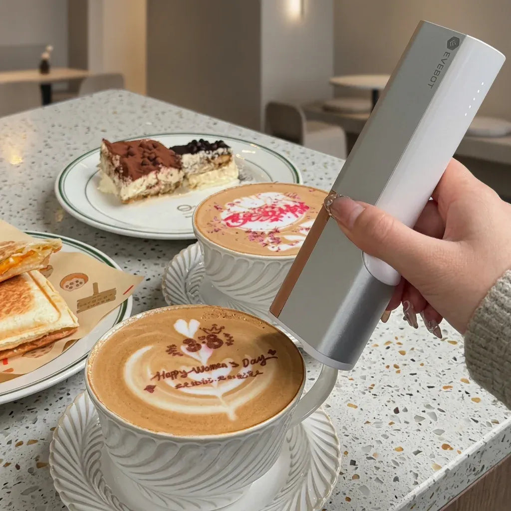 Handheld coffee inkjet printer printing on a latte cup with holiday-style design
