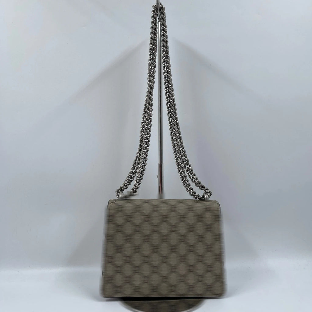 Pre-owned designer shoulder bag in beige monogram canvas with a silver chain strap, vintage luxury fashion style.