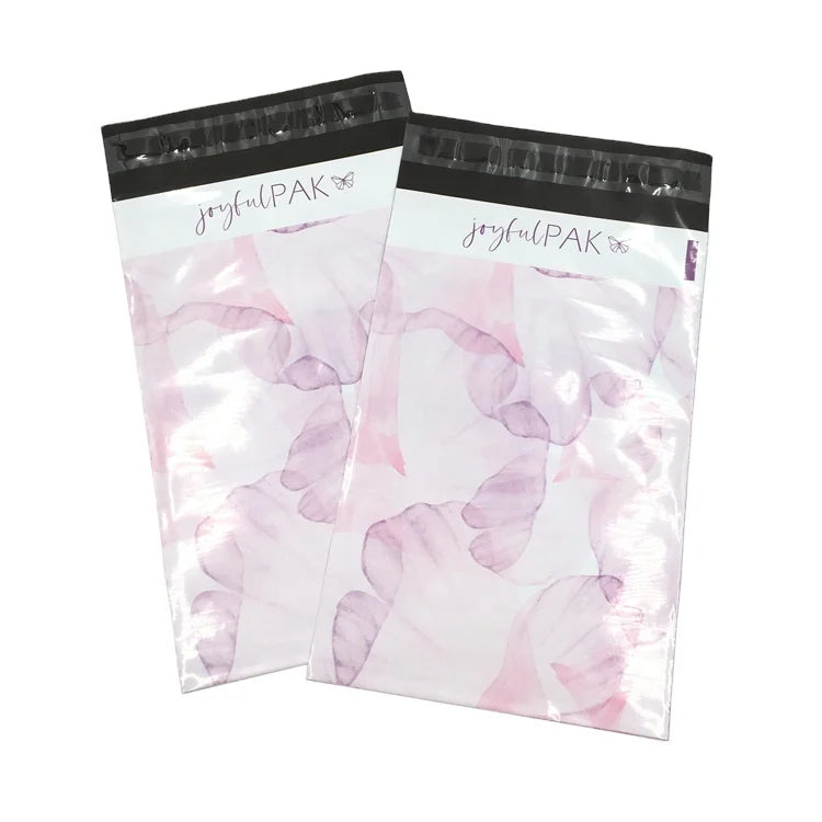Pink translucent poly mailer bag with colorful floral print and black joyfulPAK logo header