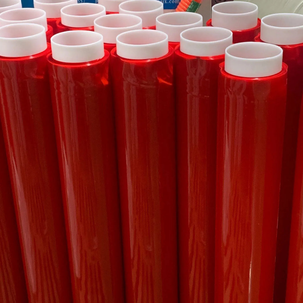 Red double-sided polyester tape rolls standing in a row with white inner cores