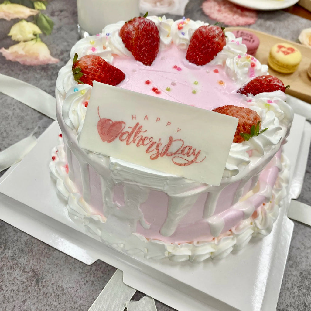 Handheld edible inkjet printer printing on a birthday cake with “Happy Mother’s Day” card.
