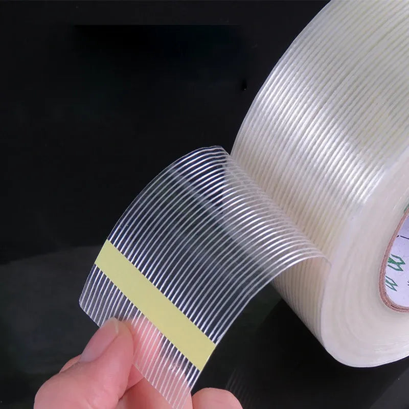 Close-up of white cross-fiber filament tape with blue parallel stripes
