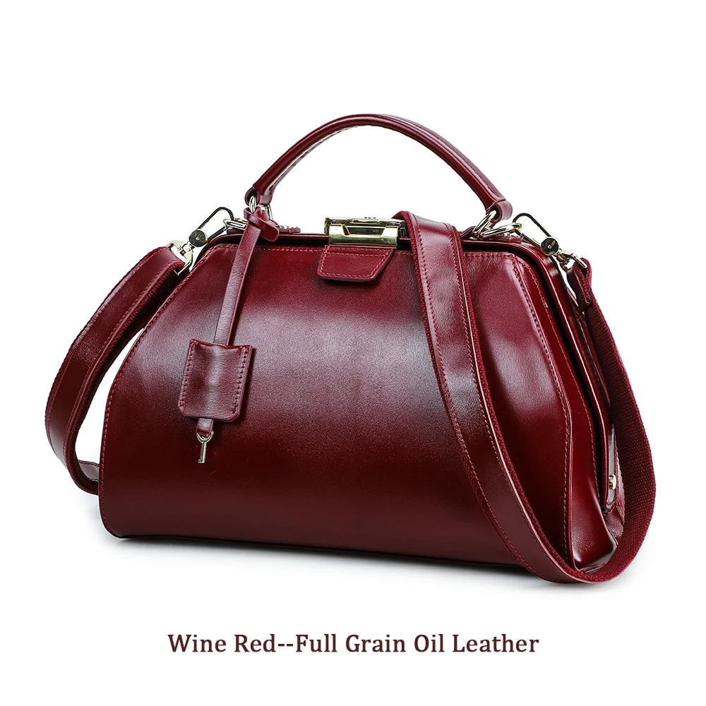 Wine red full grain leather doctor satchel handbag with top handle, detachable strap, and vintage gold lock closure.