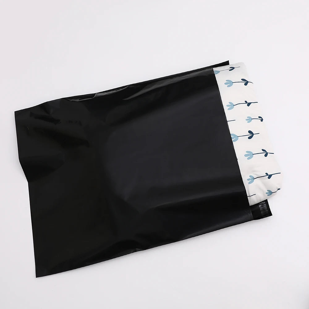 Black poly mailer envelope with blue bird-style branding on the sealed end