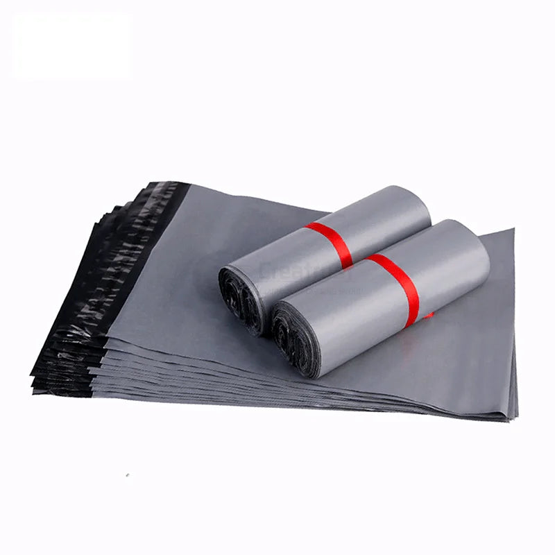 Gray plastic mailer bags with handles, stacked, sealed edge with red strip.