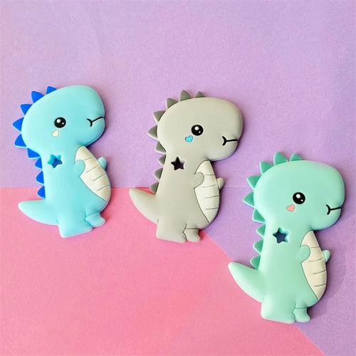 Blue, grey, and mint dinosaur silicone teething toys for baby teething relief.