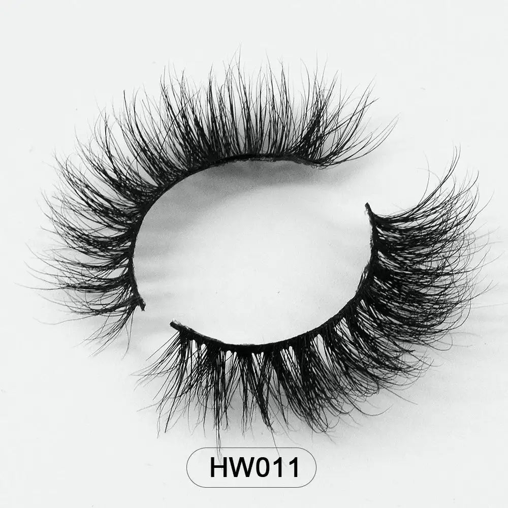 Black 3D mink false eyelashes with a soft flex band, arranged in a circular shape against a white background.