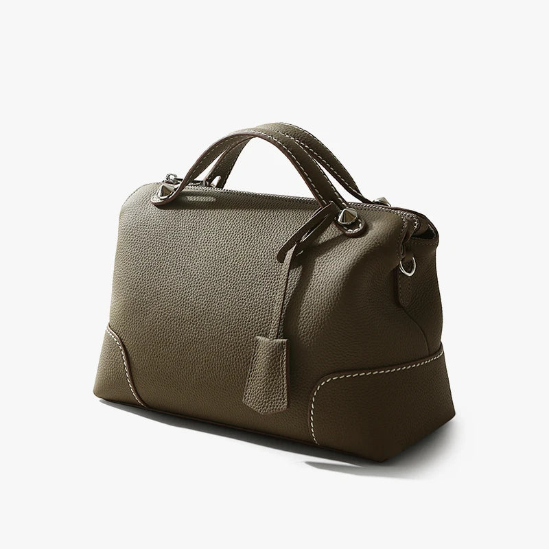 Taupe top-grain cowhide leather designer handbag featuring contrast white stitching and silver hardware accents.