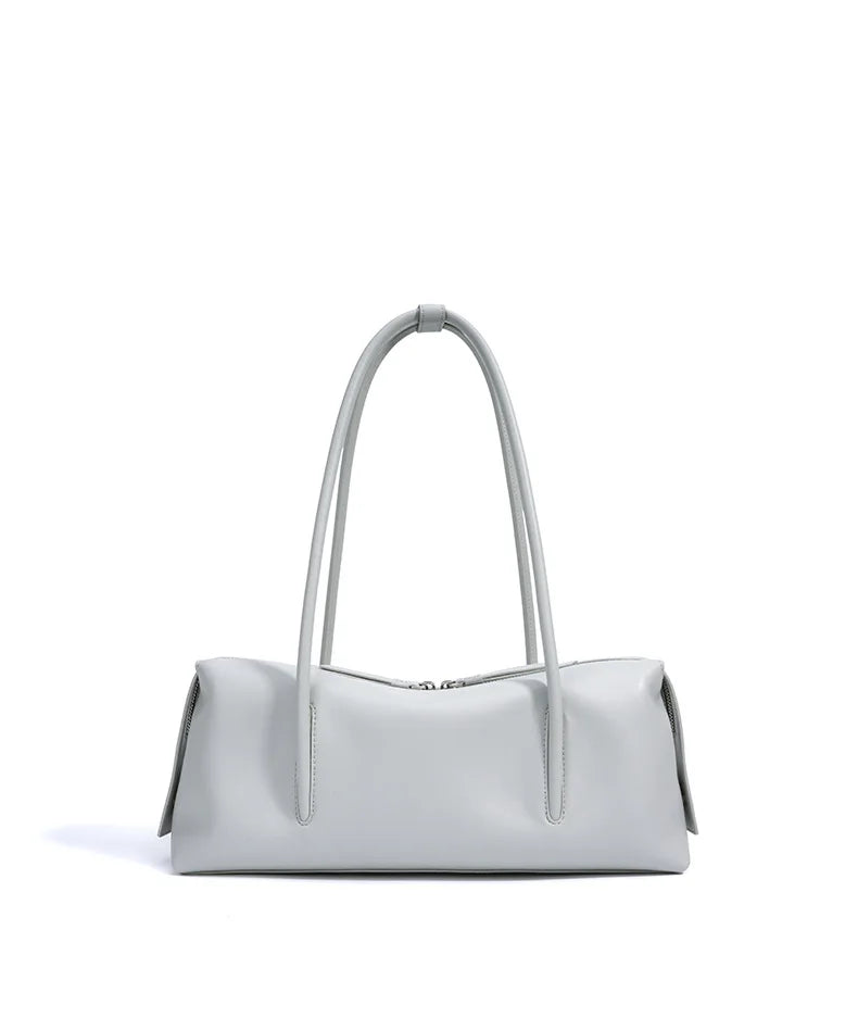 Light gray genuine cowhide leather shoulder bag, minimalist rectangular underarm trunk style with top zipper closure.