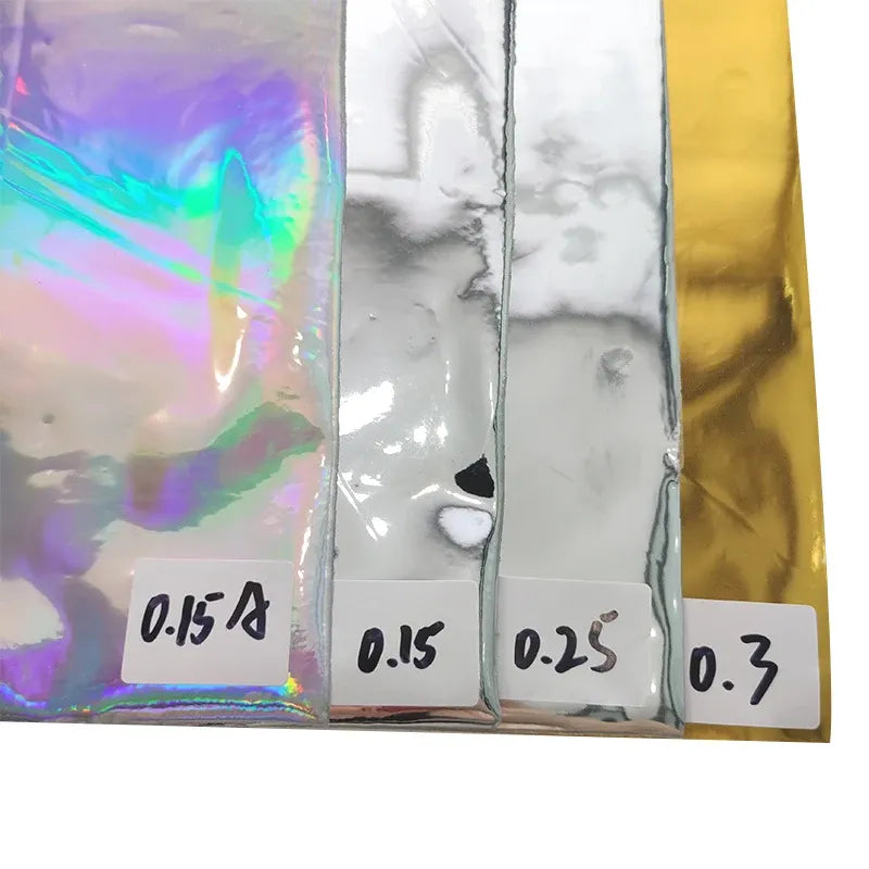 Reflective film sheets with rainbow hologram, silver, and gold mirror finish