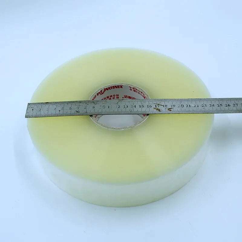 Light green tape roll with measuring ruler across the tape width
