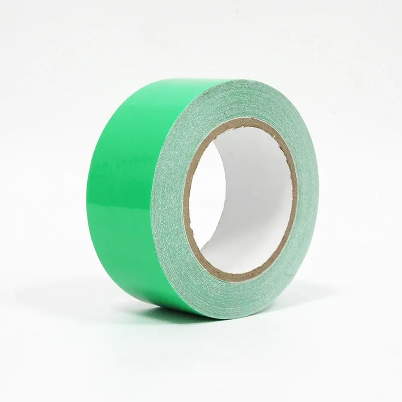 Green waterproof membrane tape roll with gray edge band and inner cardboard core