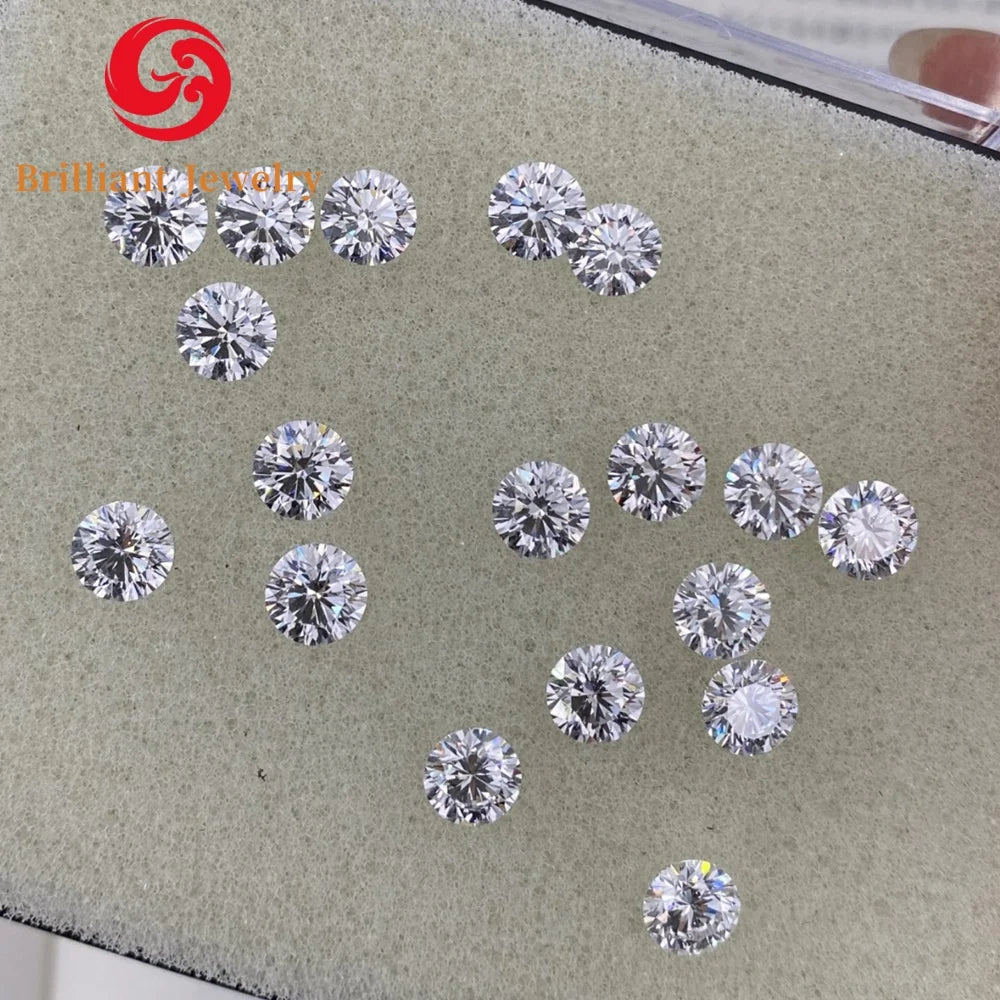 Round lab-grown diamonds loose on gray display pad, brilliant-cut sparkle