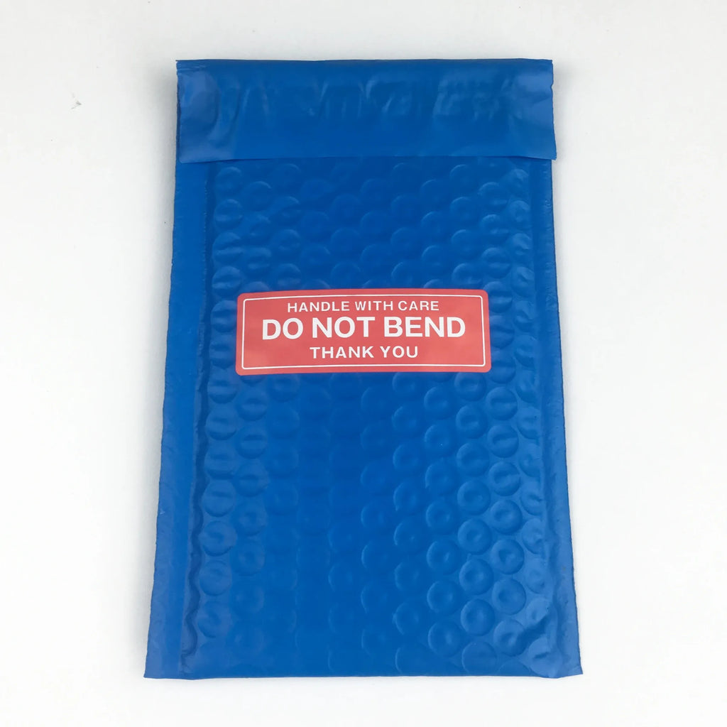 Blue padded mailer with red “Handle with care—Do not bend” warning sticker