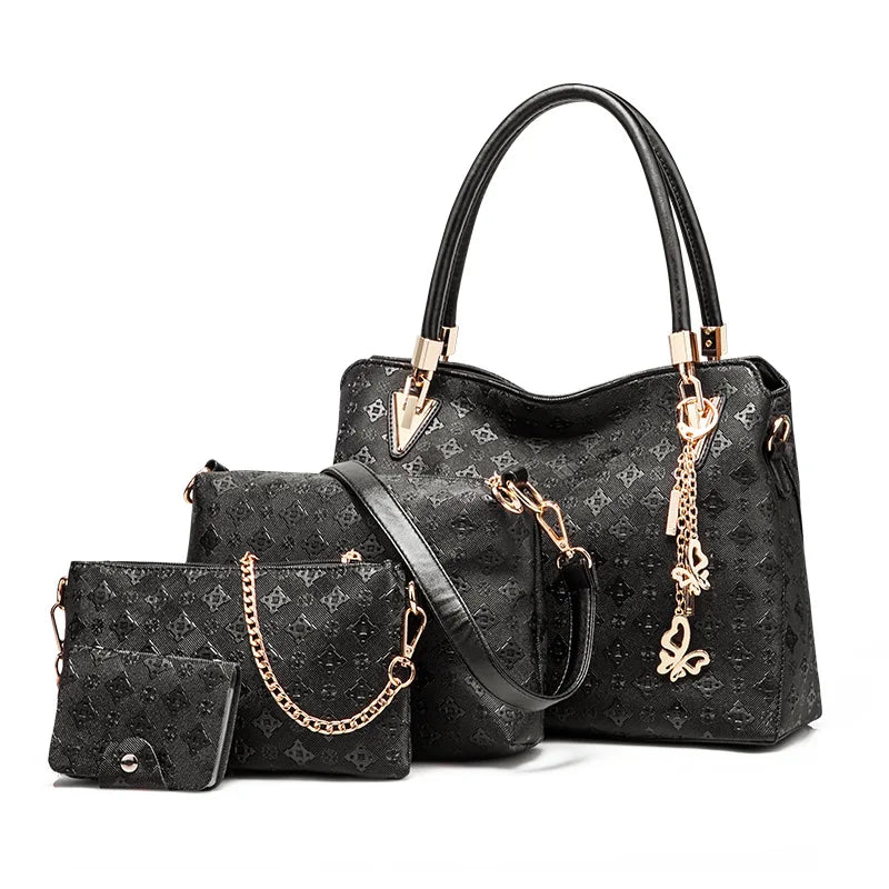 4-piece black embossed leather trunk purse set with gold butterfly charm, top handles, and chain strap details.