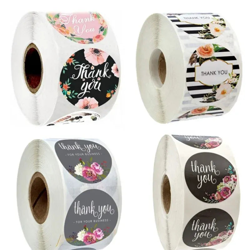 Rolls of round thank you stickers, floral designs on black and white stripes