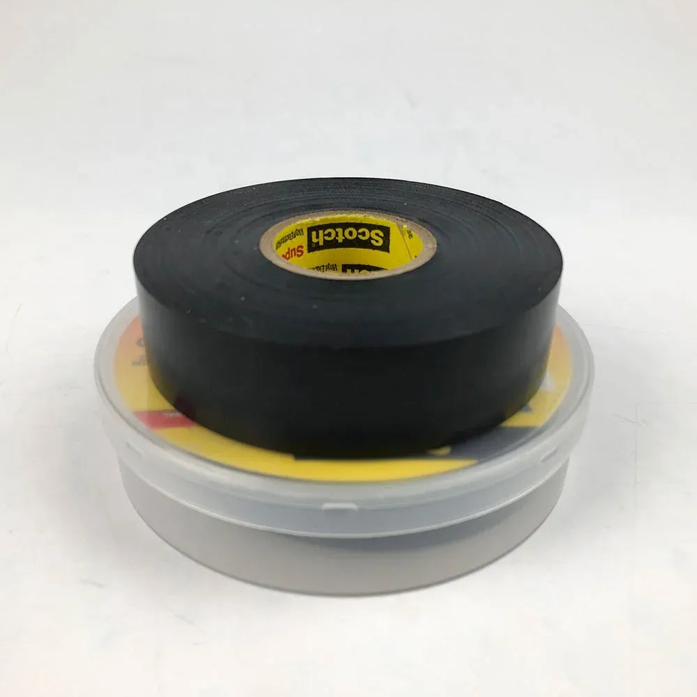 Black electrical tape roll on clear plastic spool, yellow label center