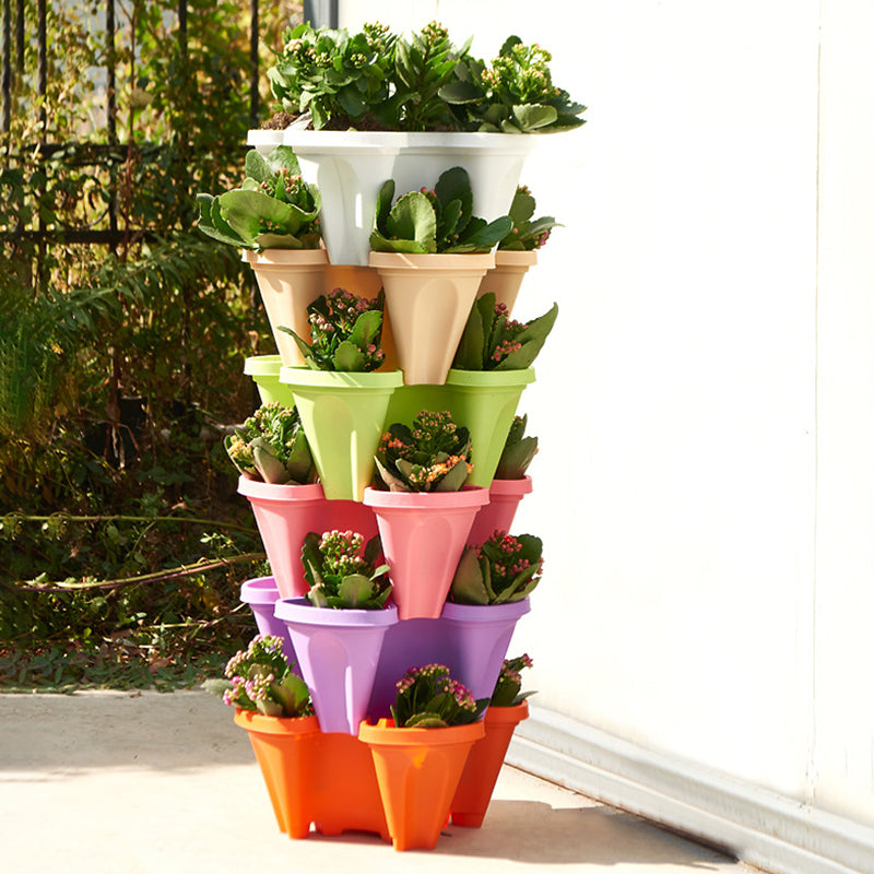 Stackable vertical plant pot tower with mixed-color plastic cups and green plants