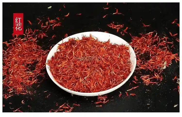 Safflower herbal foot soak powder in a white bowl for home spa health care, Chinese medicine ingredient, black bg.