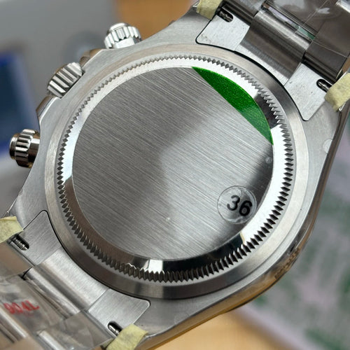Stainless steel case back of a 4130/4131 luxury mechanical sports watch with green sticker and number 36 tag.