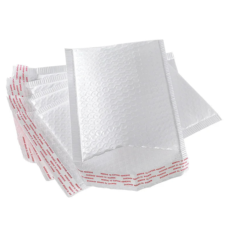 Stack of white plastic bubble mailer envelopes with printed red-and-blue strip on top