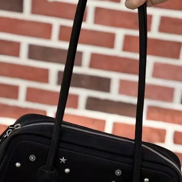 Black Korean-style shoulder tote bag with silver studs, zipper closure, and double handles, elegant trunk design.