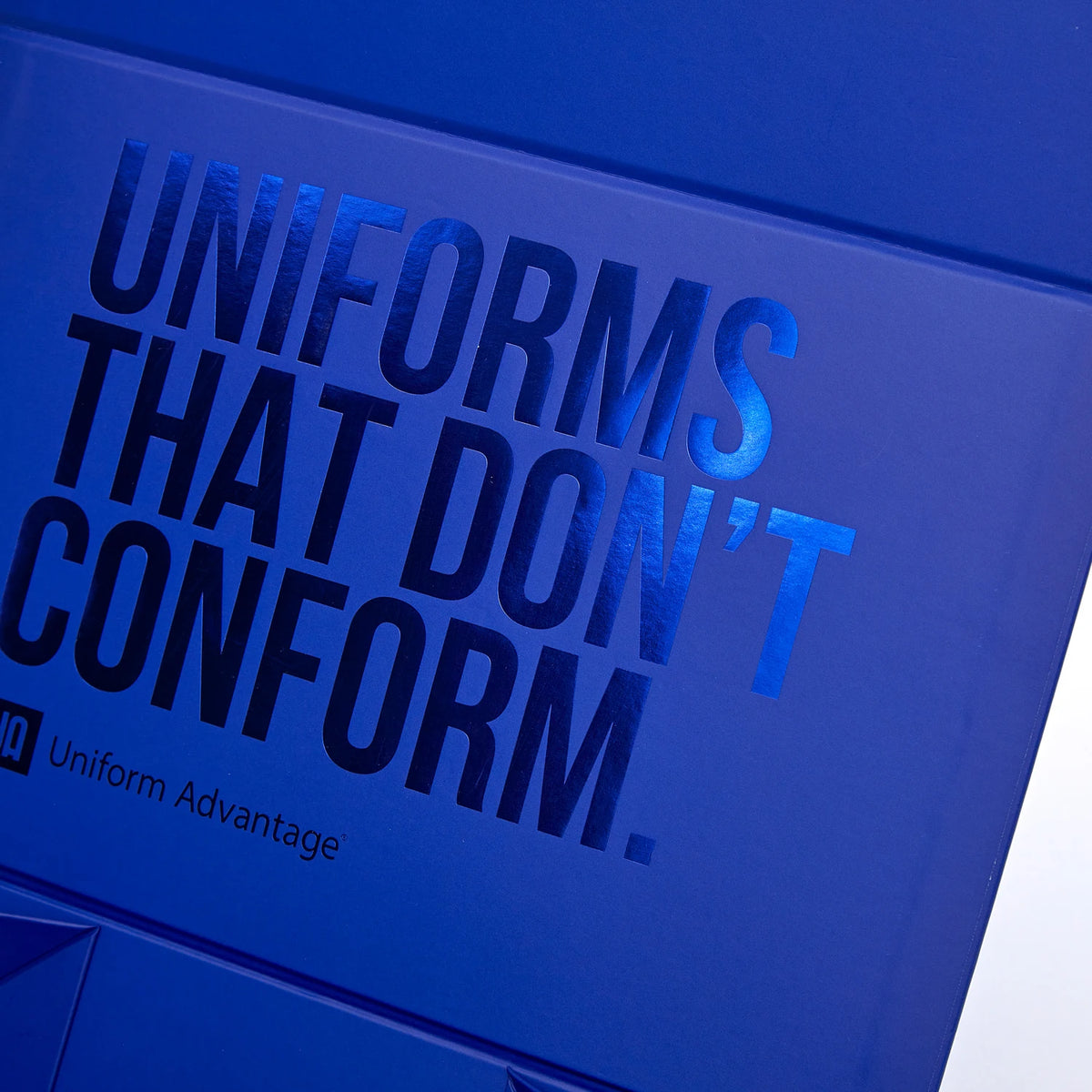 Blue corrugated mailer box lid with large embossed-style logo and branding text.