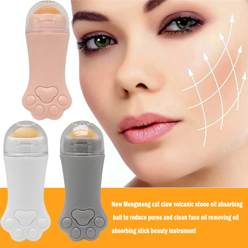 Cat paw-shaped volcanic stone oil-absorbing facial rollers in pink, white, and grey with a person using one on cheek.