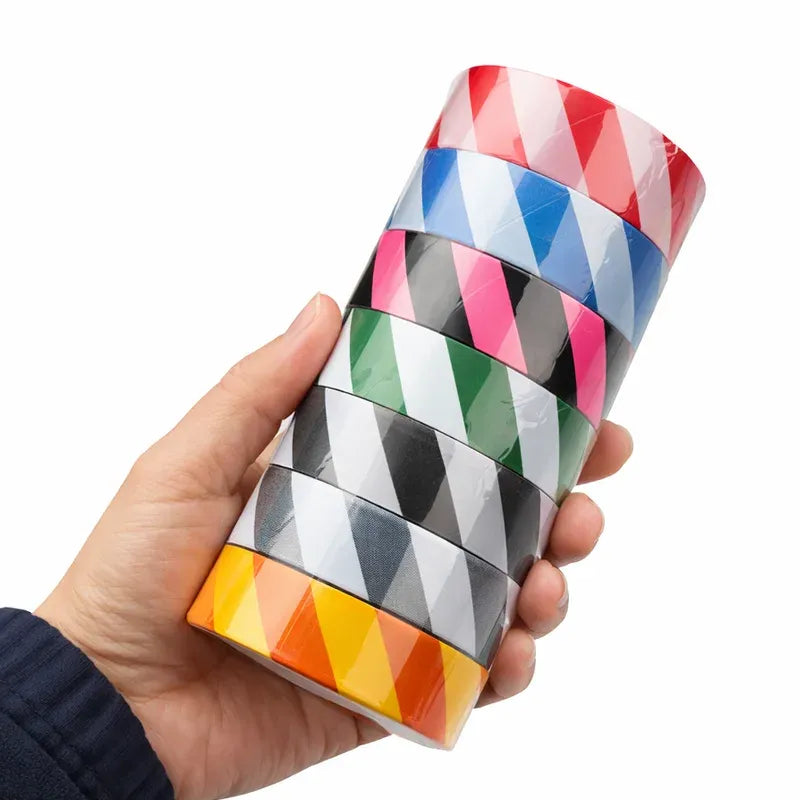 Handheld water-activated striped PVC warning tape roll, geometric pattern in mixed colors.