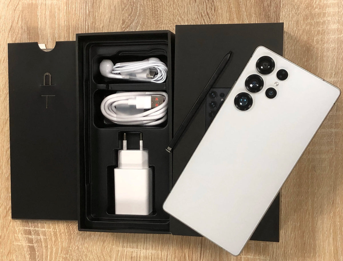 White smartphone with open retail box and charging cable set with wall adapter