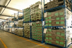 Stacked poly bubble mailers on pallets in green and brown packaging