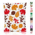 White poly mailer bag with red, orange, and brown maple leaves on a light background