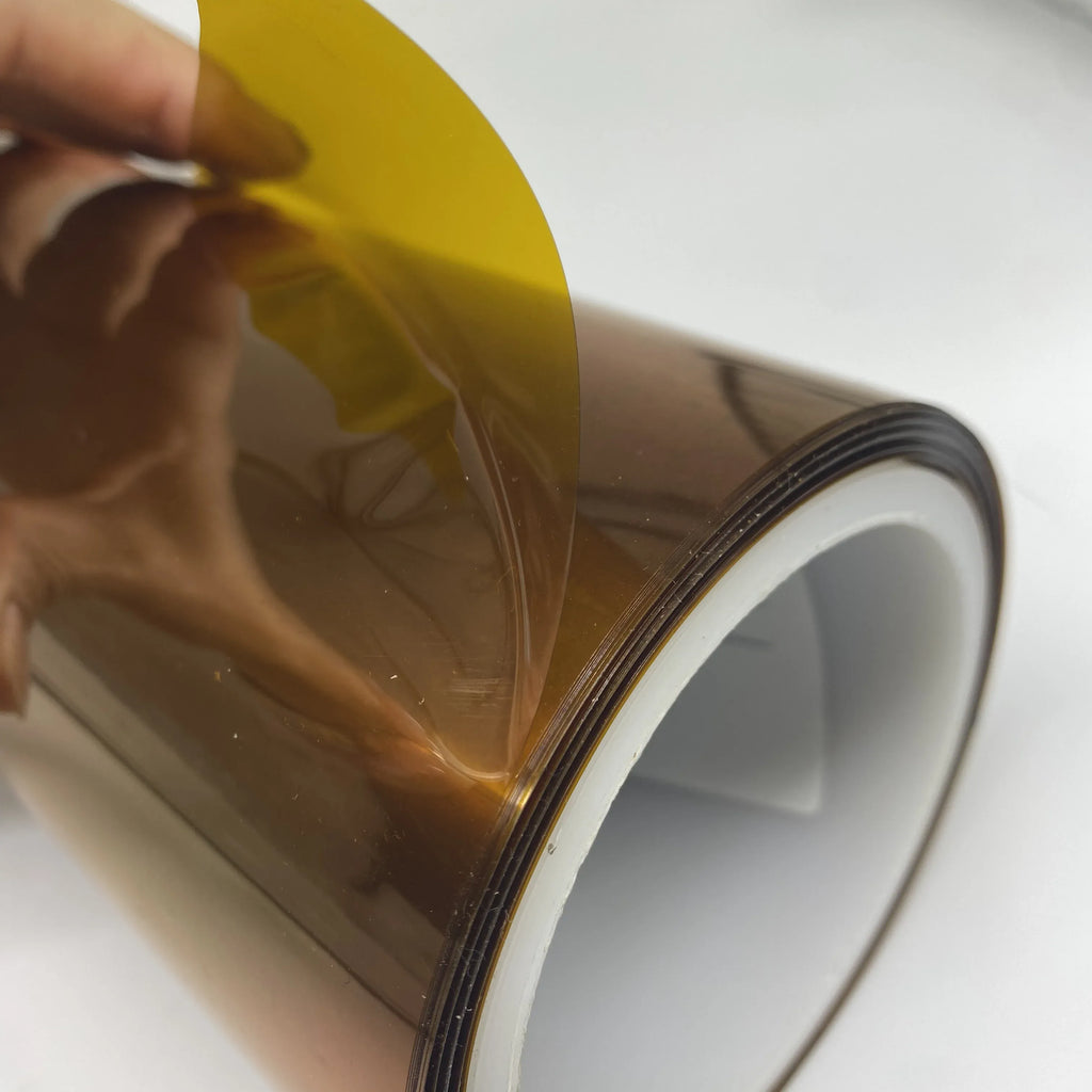 Hand holding polyimide moisture-proof tape, transparent brown film with yellow release