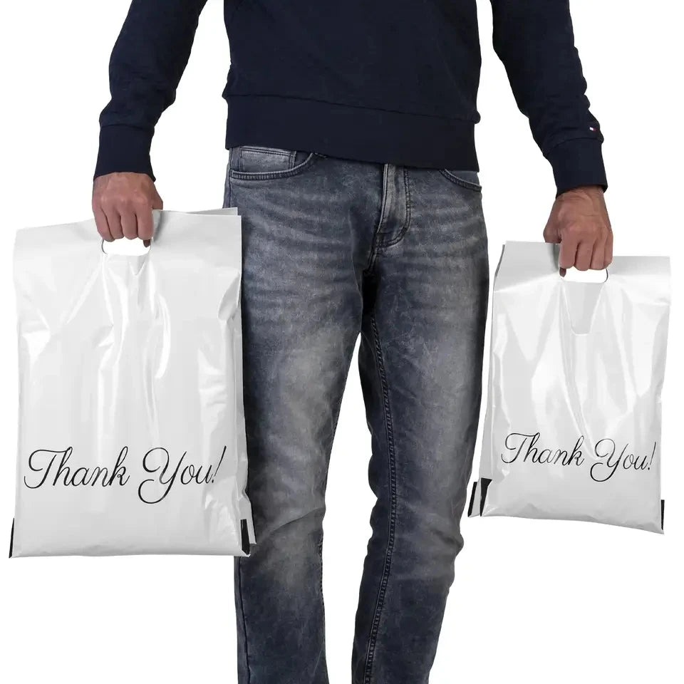 White plastic poly mailer bags with black "Thank You!" logo text, handle cutout