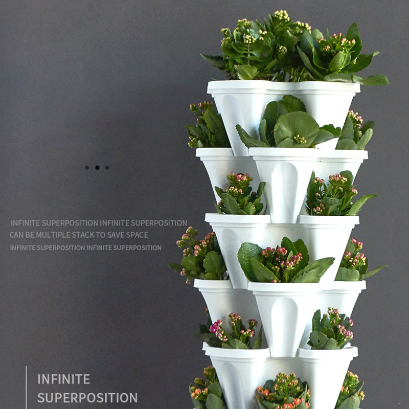 Stackable vertical plastic flower planter tower with white pots and green seedlings