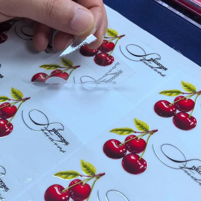 Vinyl die-cut sticker sheet with red cherries and green leaves, plus script outlines