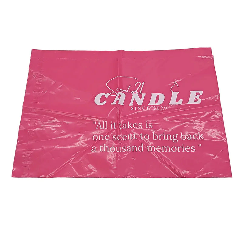 Pink poly mailer bag with white “CANDLE” logo and inspirational quote text