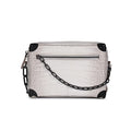White Himalayan crocodile leather trunk handbag with black metal corners and matching decorative link chain strap.